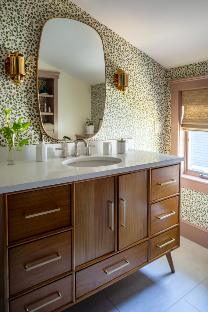 Bathroom with natural wood finished and floral wallpaper pattern